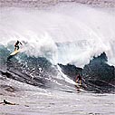 Photo of surfers on 20-ft waves at Waimea Bay, O'ahu